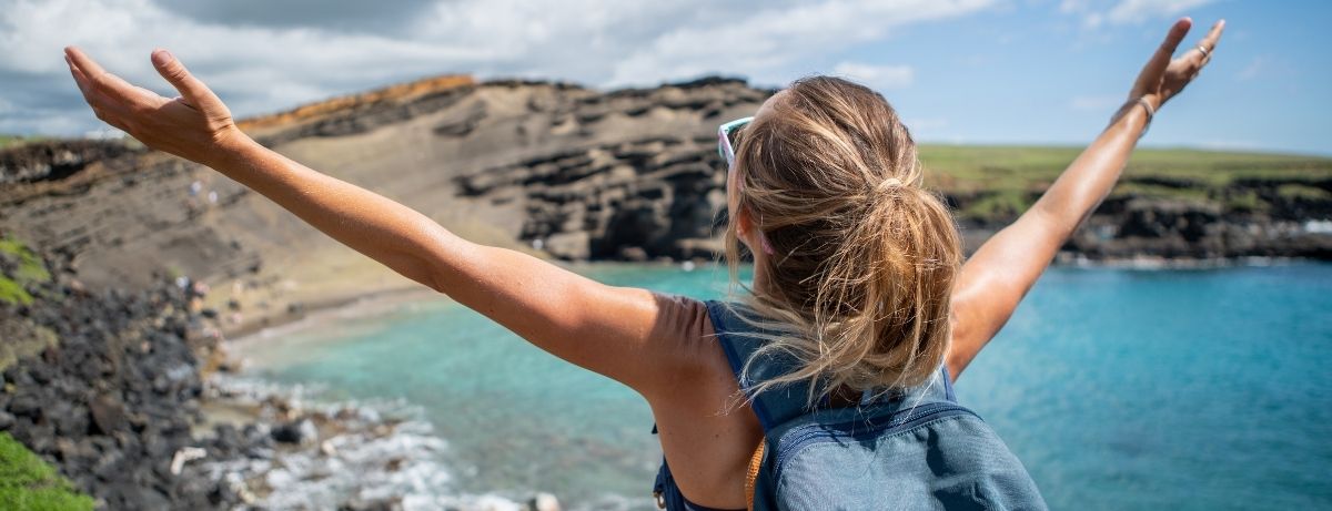 girl hiking with arms out