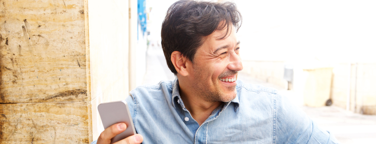 man in blue on phone