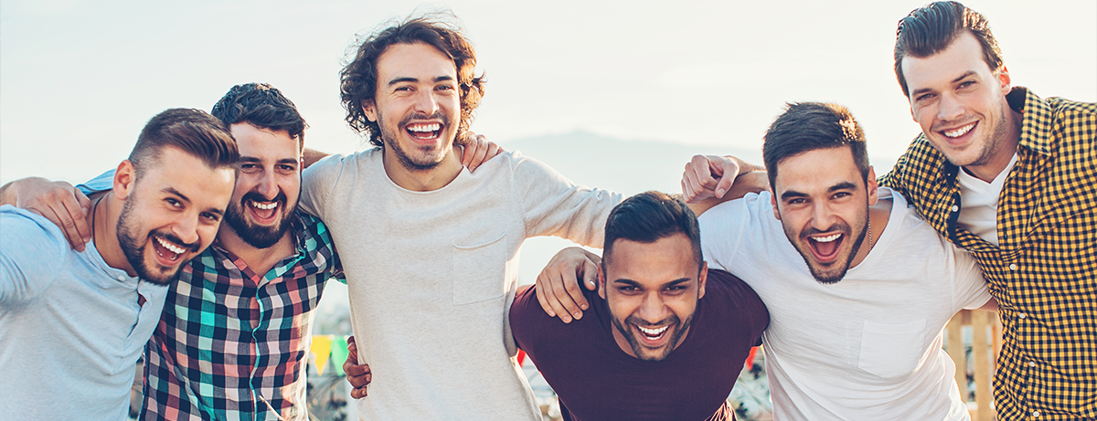 group of young men laughing outside