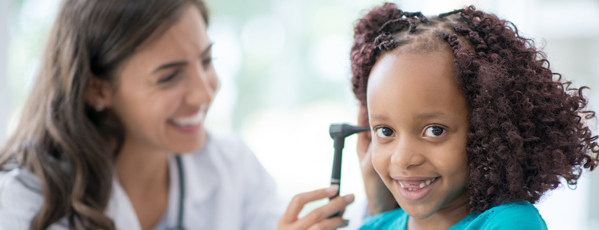 Doctor looking in child's ear