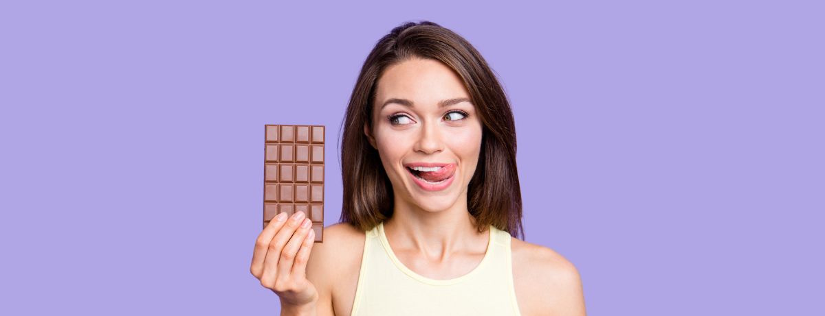 woman holding chocolate bar