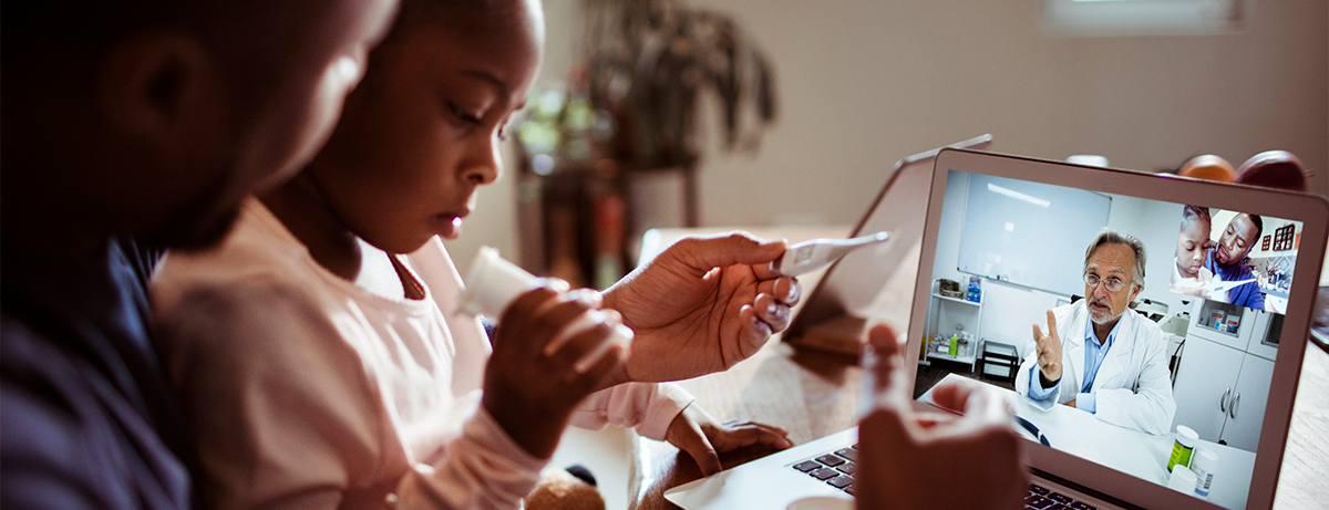 father and sick child on a telehealth visit