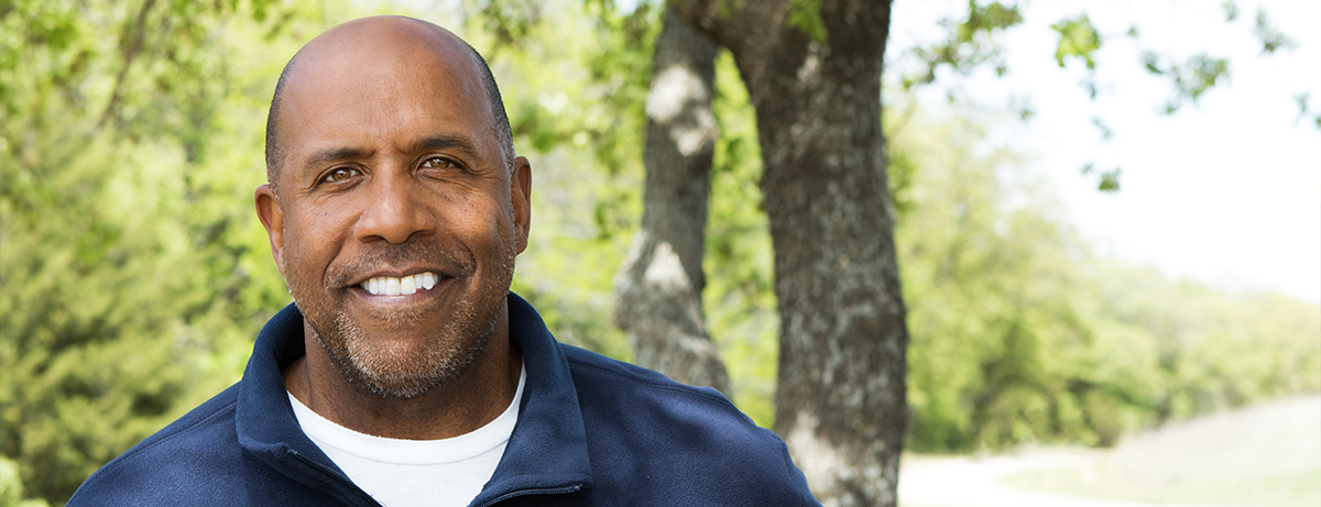 older black man in blue sweater outside