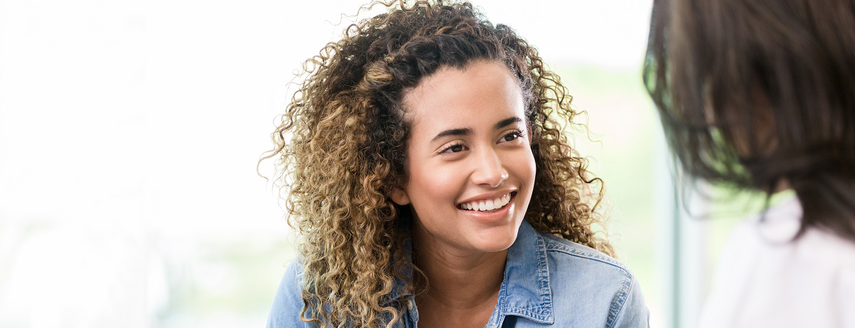 happy young female patient talking to doctor