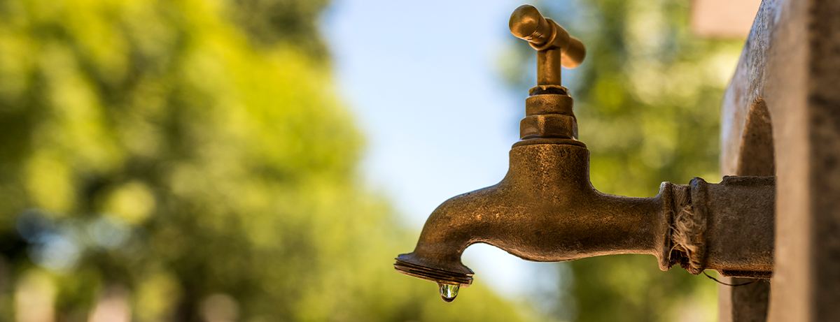 old rusty faucet with water dripping