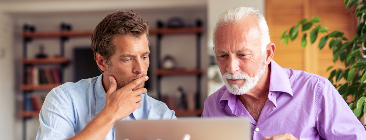 two men looking at laptop