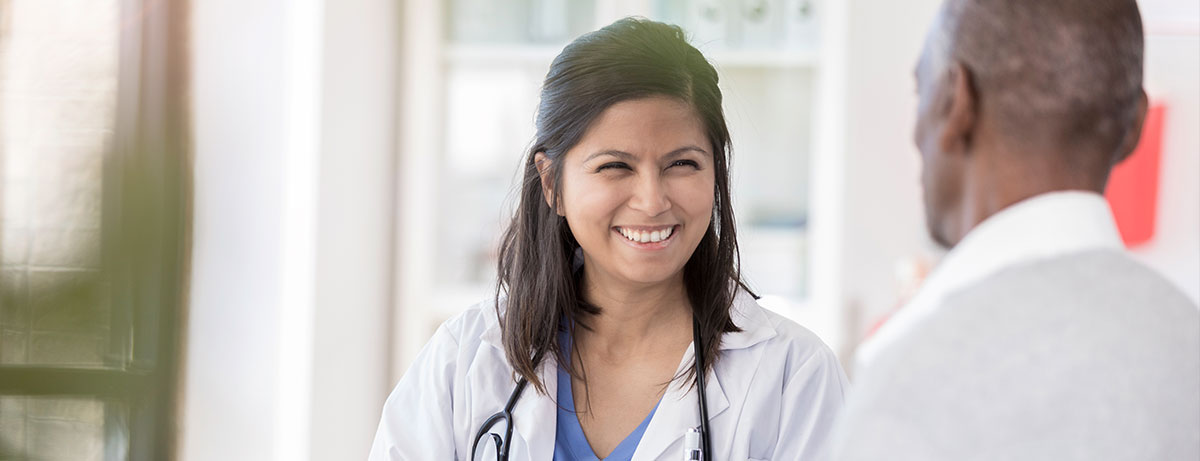 Smiling nurse with senior patient