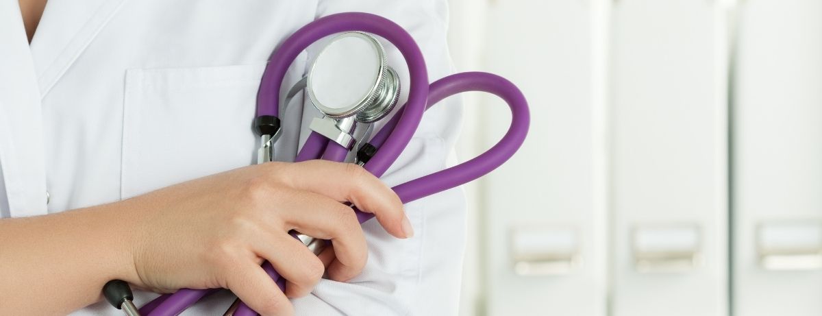close up of doc holding purple stethoscope