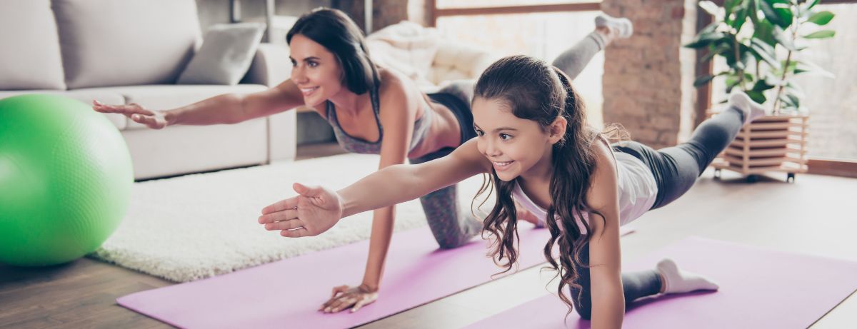 girl and mom doing yoga