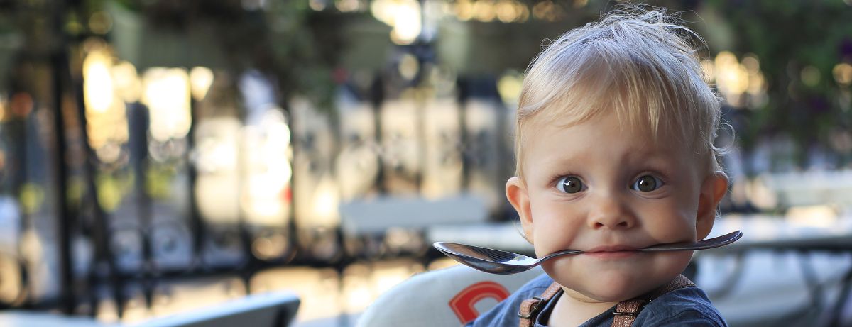 baby with spoon in mouth
