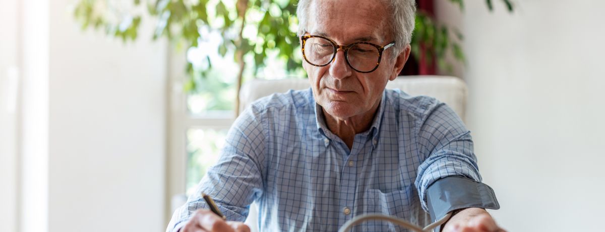 man taking blood pressure at home