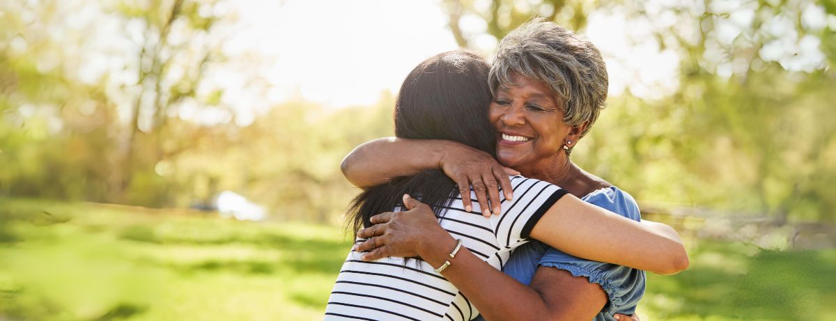 young woman hugging older woman