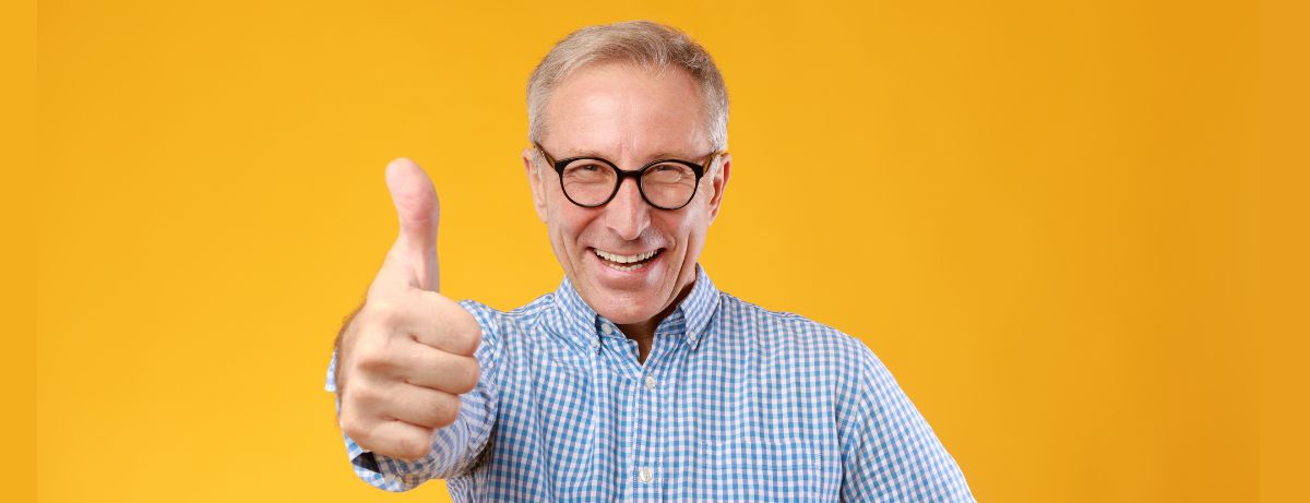 senior man giving thumbs up