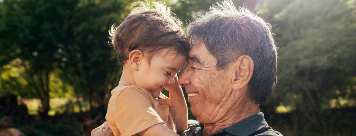 senior man cuddling grandson